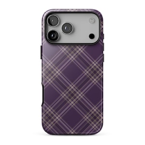 Puede incluir: Una funda para smartphone con fondo morado oscuro y un patrón de cuadros en diagonal formado por finas líneas blancas y marrón claro. La parte superior incluye un recorte rectangular para el módulo de cámara con tres lentes y un flash.