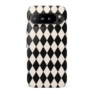 May include: A smartphone case featuring a repeating black and off-white diamond harlequin pattern. The case has a horizontal cutout at the top for the camera module, which contains three circular lenses and a flash, all set against a black background.