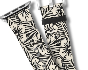 May include: A watch strap featuring a repeating pattern of black hibiscus flowers and palm leaves on a cream-coloured background. The strap includes a silver-toned metal buckle, a black silicone keeper loop, and a silver-toned metal connector attachment.
