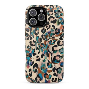 May include: A phone case with a cream-colored background and a pattern of black leopard spots and teal, blue, and brown floral accents. The case has a camera cutout and a glossy finish.
