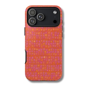 May include: A phone case with a vibrant, abstract pattern of orange and pink circles. The case has a black camera module and a black side button. The overall design is eye-catching and modern, suitable for protecting a smartphone.