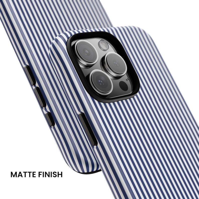 May include: A smartphone case featuring a blue and white vertical pinstripe pattern with a matte finish. The case has a black camera cutout frame and black side buttons, designed to fit a device with a triple-lens rear camera system.