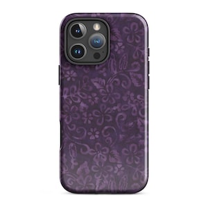May include: A purple phone case with a floral pattern. The case has a glossy finish and features a design of stylized flowers and leaves in varying shades of purple. The camera lenses are visible at the top.