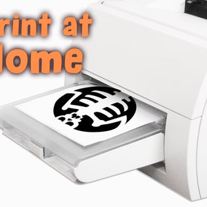 May include: A white printer with a black and white design being printed on a sheet of paper. The printer has the words "Print at Home" in orange text.
