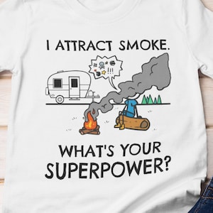May include: White t-shirt with a funny camping illustration and the text "I attract smoke. What's your superpower?"
