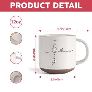 May include: White ceramic mug with a brown base, featuring a minimalist bunny design with a halo and the name "Sophie". The mug is 9cm in diameter and 9cm tall, with a capacity of 12oz.