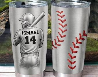May include: A pair of stainless steel insulated tumblers. One features a baseball player graphic with the name "ISMAEL" and the number "14". The other tumbler has a baseball seam design in red.