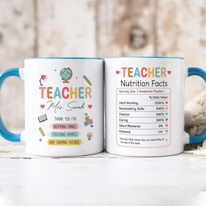 May include: A white ceramic mug with a blue handle and rim, featuring colorful graphics of a globe, pencil, book, and lightbulb. The text reads Teacher Mrs. Sarah, Thank you for inspiring minds, touching hearts, and shaping futures, plus a nutrition facts label.