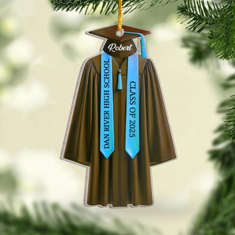May include: A brown graduation gown ornament with blue sashes. The sashes are personalized with the text "Robert", "Dan River High School", and "Class of 2025".
