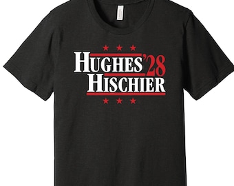 May include: Black t-shirt with white text that reads "Hughes '28 Hischier" in red. There are five red stars above and below the text.
