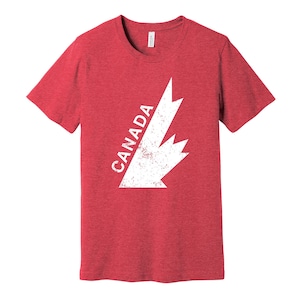 May include: Red heather t-shirt with a white distressed graphic of a Canadian maple leaf and the word "CANADA".