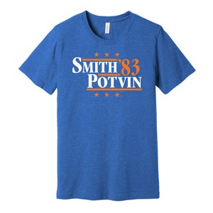 May include: A royal blue t-shirt with a white and orange graphic that says "Smith '83 Potvin".