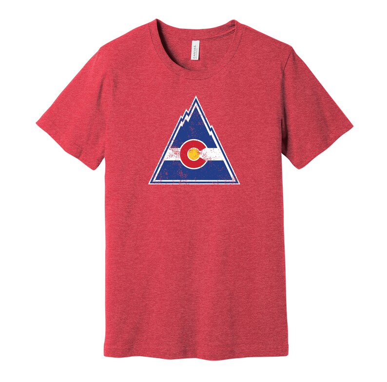 May include: Red t-shirt with a distressed graphic of a mountain range and the Colorado state flag.