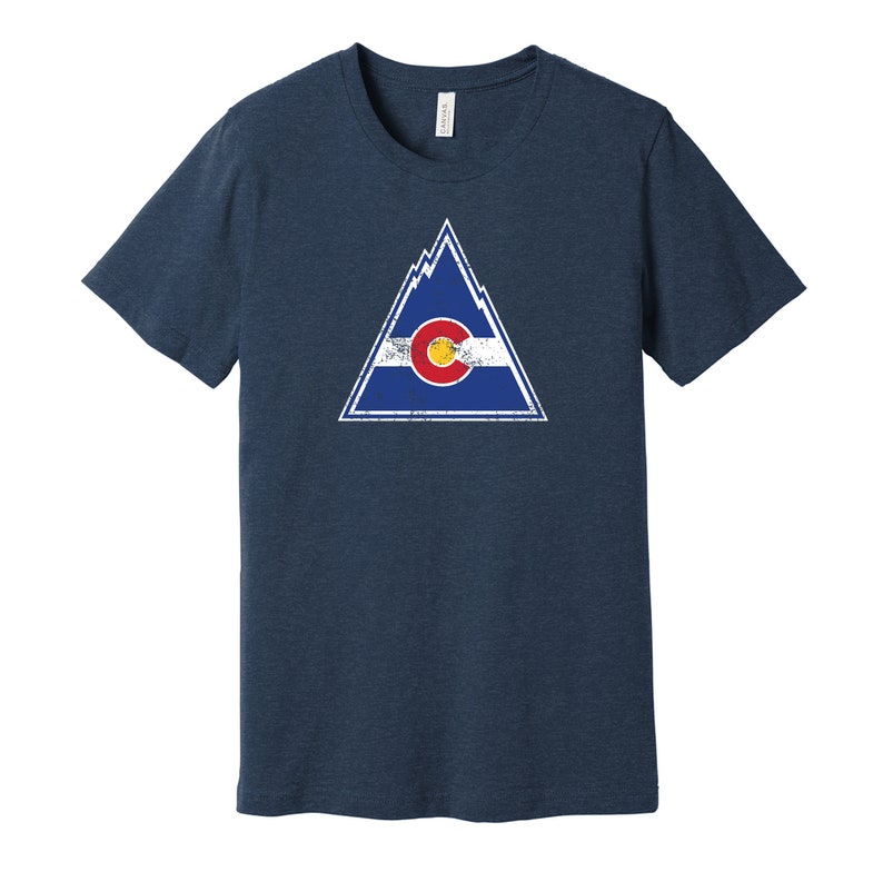 May include: A navy blue t-shirt with a distressed graphic of a mountain range and the Colorado state flag inside a triangle.