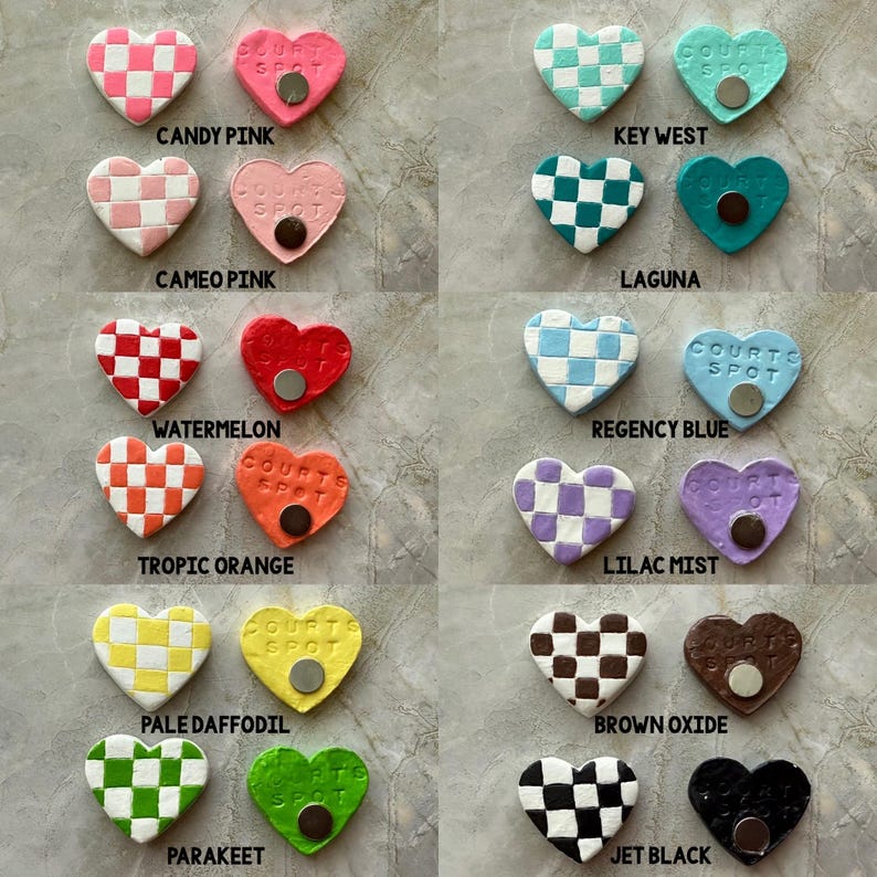 May include: A selection of heart-shaped magnets in a variety of colours and patterns. Some feature a checkerboard design, while others are solid. Each magnet has the text "COURT SPOT" and a small, round magnet on the back. Colours include pink, blue, green, and brown.