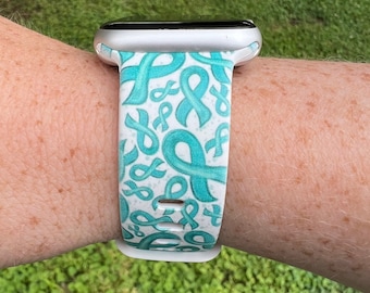 Może przedstawiać: Biały pasek do Apple Watch z wzorem turkusowych wstążek.