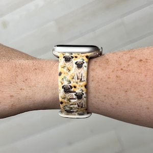 May include: A white Apple Watch band with a pattern of pugs and sunflowers.