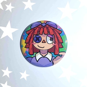 May include: A colorful button featuring a cartoon girl with red hair, a purple dress, and a single eye patch. The background is a rainbow of colors with stars.