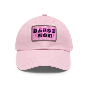 May include: Pink baseball cap with a pink and black patch that says "Dance Mom" with pink silhouettes of dancers on the patch.