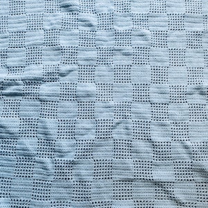 May include: A light blue crocheted blanket with a repeating pattern of circles.