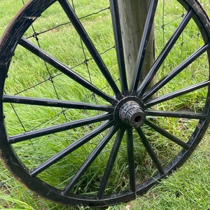 Used Wagon Wheels for sale, These authentic Amish buggy wheels are used and great for decorating.  Made from wood with metal bands and hubs.