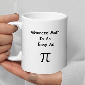 May include: White ceramic mug with a black inscription that reads "Advanced Math Is As Easy As Pi".