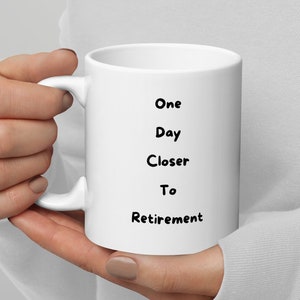 May include: White ceramic mug with black text that reads "One Day Closer To Retirement".