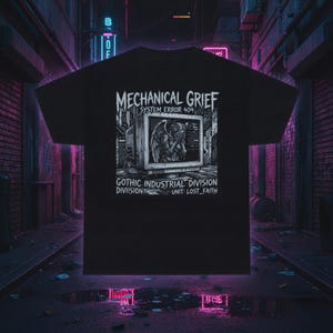 May include: A black t-shirt featuring a white graphic print of a computer monitor displaying a winged figure. The text reads MECHANICAL GRIEF SYSTEM ERROR 404 GOTHIC INDUSTRIAL DIVISION DIVIISION UNIT: LOST_FAITH in a distressed, stylized font.