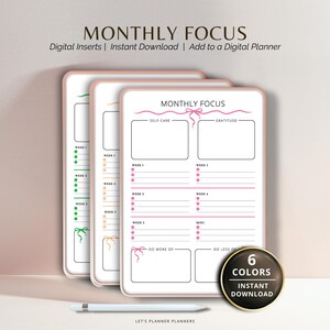 May include: Three digital planner inserts with a pink border, featuring the text "MONTHLY FOCUS". Each insert includes sections for self-care, gratitude, and weekly notes. A button indicates "6 COLORS" and "INSTANT DOWNLOAD". A stylus pen rests below.