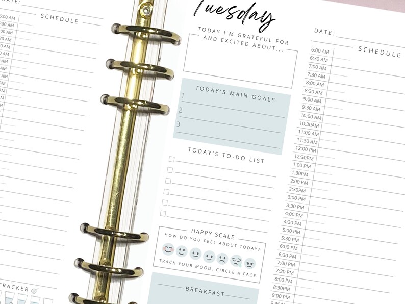 May include: A weekly planner with a blue and white color scheme. The planner has a section for "Today's Main Goals", "Today's To-Do List", and a "Happy Scale" with emojis to track your mood.