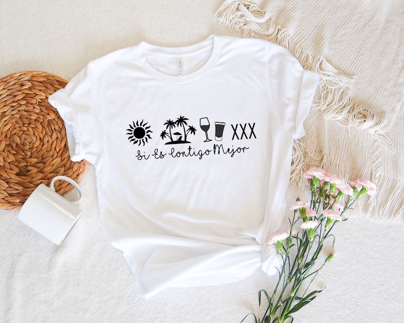 May include: White t-shirt with a black sun, palm trees, wine glass, beer glass, and the text "Si es contigo Mejor" printed on the front.