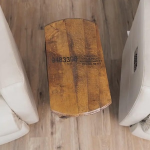 Op de afbeelding: Een tafel gemaakt van een houten vatenkop met een natuurlijke eiken afwerking en zichtbare houtnerf. De bovenkant bevat de zwarte gestempelde tekst 9483308 en Heaven Hill Distilleries Inc. Bourbon Whiskey Rolling Fork KY-1.