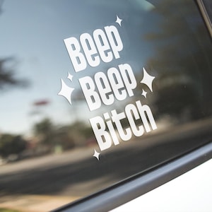 May include: White vinyl car sticker with the text "Beep Beep Bitch" and small star designs.