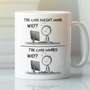 May include: White ceramic mug with a humorous design. The mug features a two-panel illustration with the text "THE CODE DOESN'T WORK WHY?" and "THE CODE WORKS WHY?" along with stick figures at a computer. The mug has a white handle.