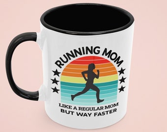 May include: White ceramic mug with a black rim and handle. The mug features a retro-style graphic of a running person with the text "Running Mom Like a Regular Mom But Way Faster".
