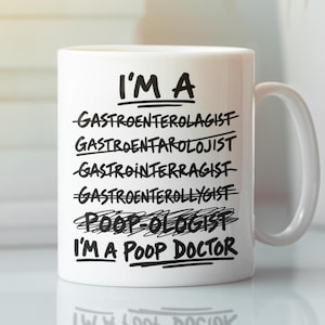 May include: A white ceramic mug featuring black text that reads: I'M A GASTROENTEROLAGIST, GASTROENTAROLOJIST, GASTROINTERRAGIST, GASTROENTEROLLYGIST, POOP-OLOGIST, I'M A POOP DOCTOR. Several of the words are crossed out with a horizontal black line.
