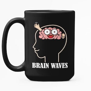 May include: Black ceramic mug with a white graphic of a brain inside a head silhouette. The brain has eyes and is waving. The words "BRAIN WAVES" are printed in white below the head.