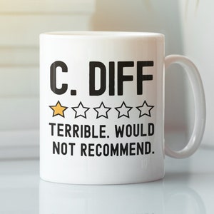 May include: White ceramic coffee mug with black text that reads "C. DIFF" and a one-star rating. The text below the rating reads "Terrible. Would not recommend."