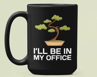 May include: Black coffee mug with a white design of a bonsai tree and the text "I'll be in my office".