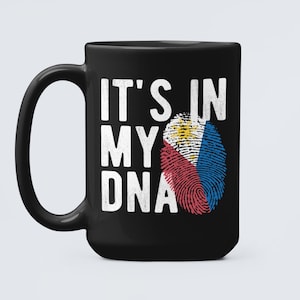 May include: Black coffee mug with a white design that says "It's in my DNA" with a fingerprint graphic of the Philippine flag.