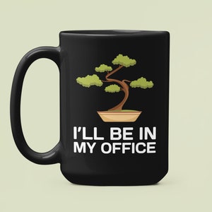May include: Black coffee mug with a white design of a bonsai tree and the text "I'll be in my office".