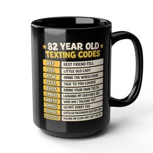 Può includere: Una tazza in ceramica nera con il testo giallo e bianco 82 YEAR OLD TEXTING CODES seguito da un elenco di acronimi umoristici e i loro significati, tra cui BFF Best Friend Fell, LOL Little Old Lady e ROFLACGU Rolling on floor and can't get up.