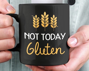 May include: Black coffee mug with a white graphic that says "Not Today Gluten" with a crossed-out wheat stalk graphic.