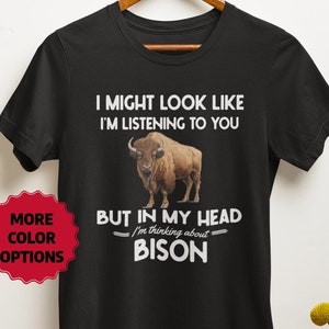 May include: Black t-shirt with a white graphic of a bison and the text "I might look like I'm listening to you, but in my head I'm thinking about bison".