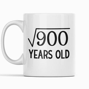 May include: White ceramic mug with black text that reads "√900 YEARS OLD".