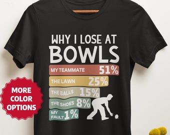 May include: Black t-shirt with the text "WHY I LOSE AT BOWLS" and a humorous pie chart. The chart lists reasons for losing, including "MY TEAMMATE" at 51% and "MY FAULT" at 1%. A red "MORE COLOR OPTIONS" sticker is visible.