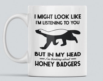 May include: White ceramic mug with a black and white illustration of a honey badger and the text "I might look like I'm listening to you but in my head I'm thinking about honey badgers."