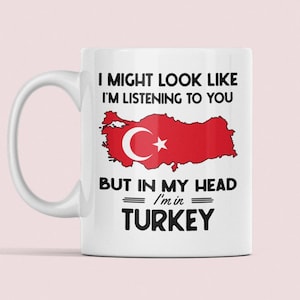May include: White ceramic mug with a black outline of Turkey and the text "I might look like I'm listening to you, but in my head I'm in Turkey".