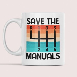 May include: White ceramic mug with a colorful vintage-style graphic of a 6-speed manual transmission shifter and the text "SAVE THE MANUALS".
