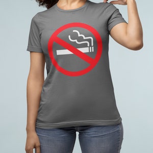May include: A charcoal gray t-shirt with a red circle and a white line through it. The circle has a white cigarette with smoke coming out of it. The text "No Smoking" is not visible in the image.
